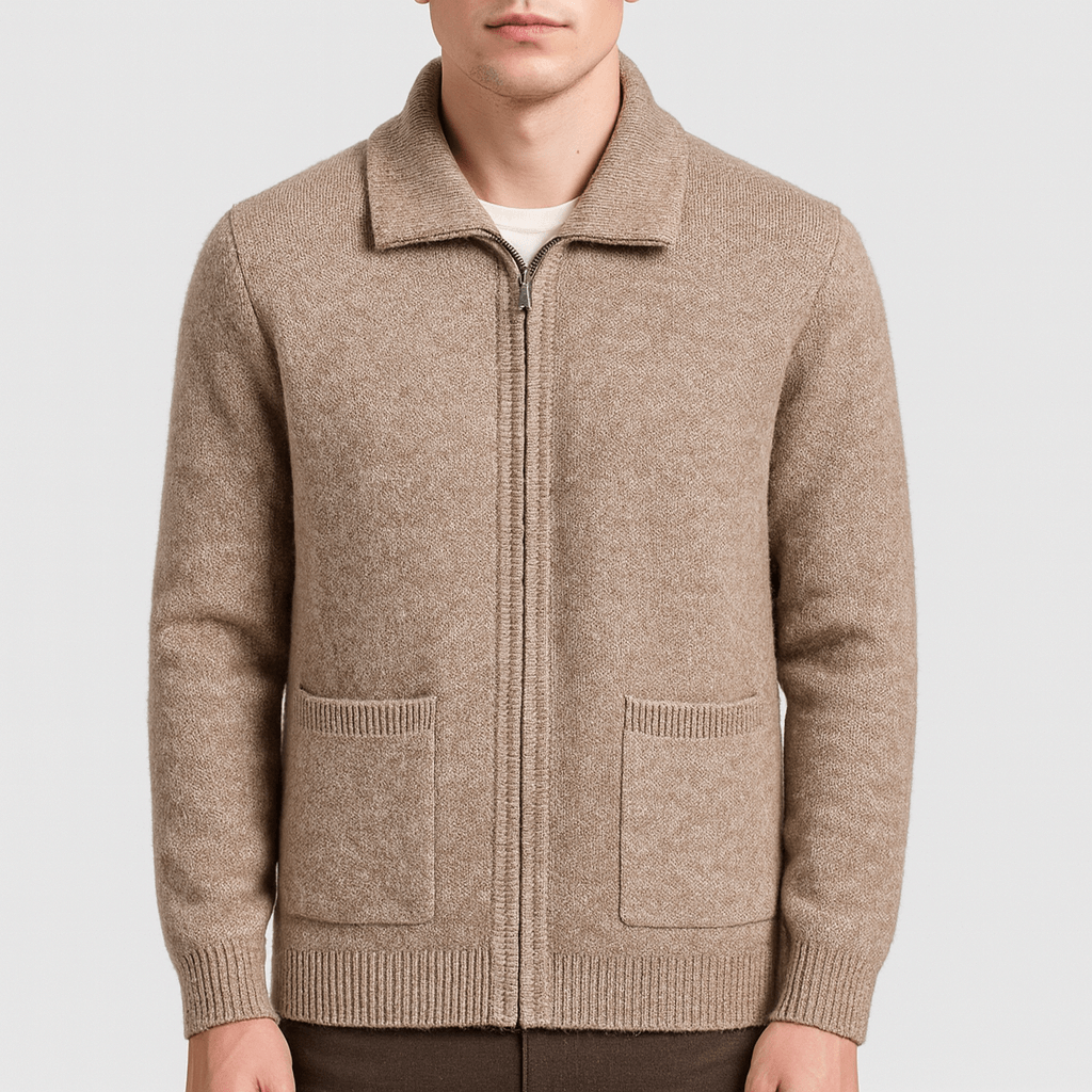 Man wearing a beige zip-up sweater on a light gray background