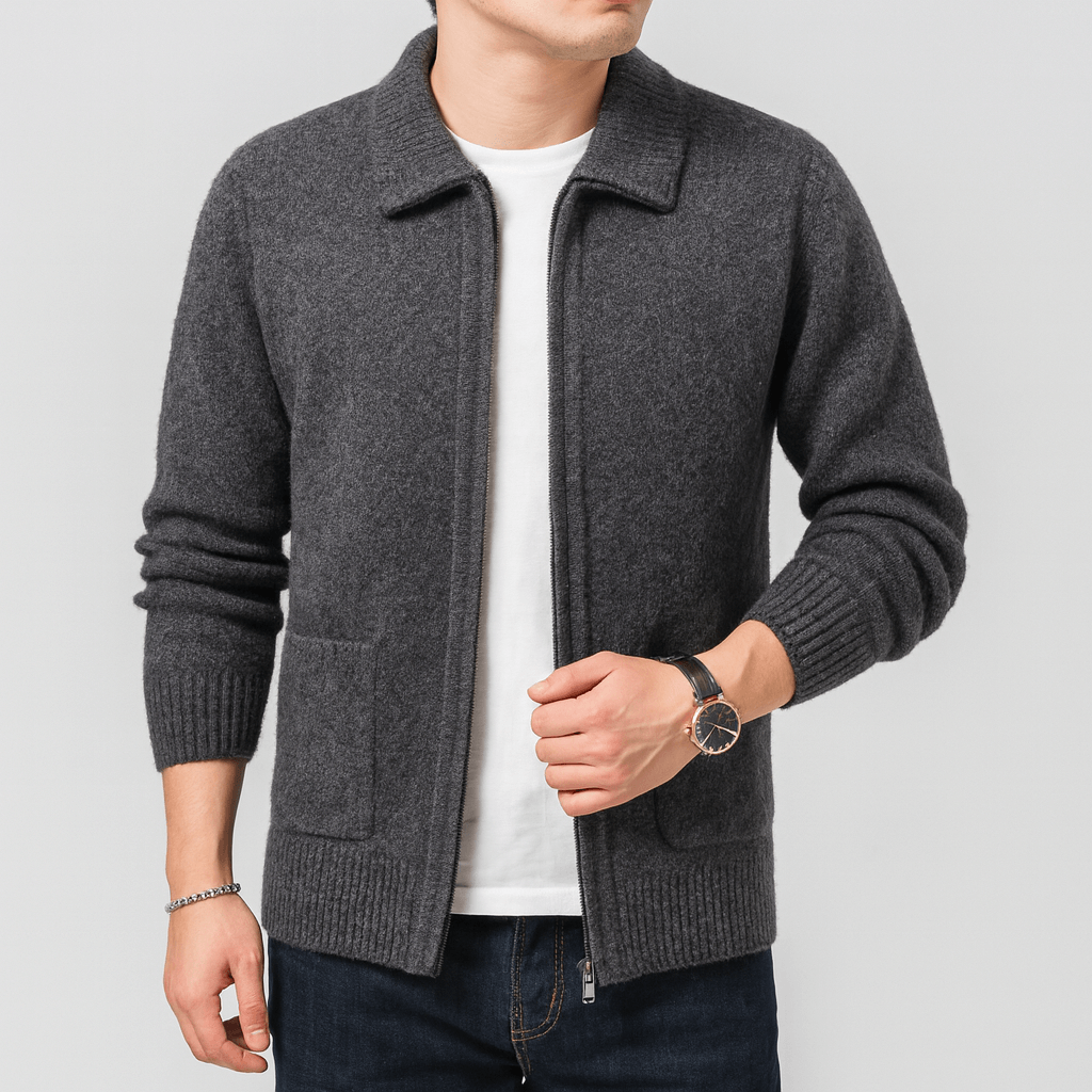 Man wearing a gray knitted cardigan over a white shirt on a light gray background